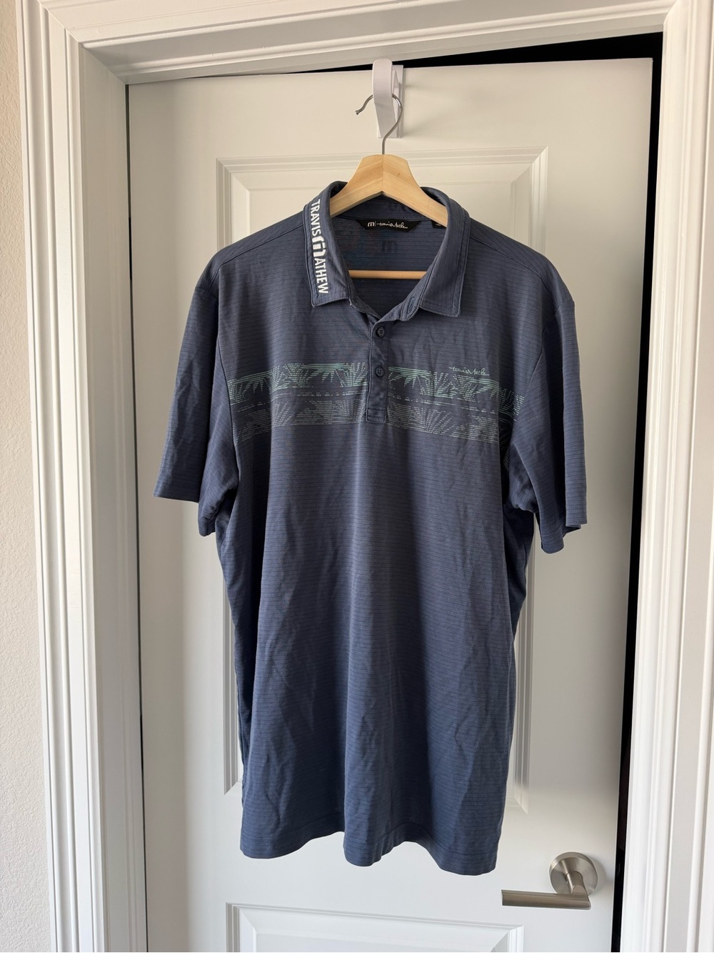 Travis Mathew Navy Polo with Subtle Palm Stripe